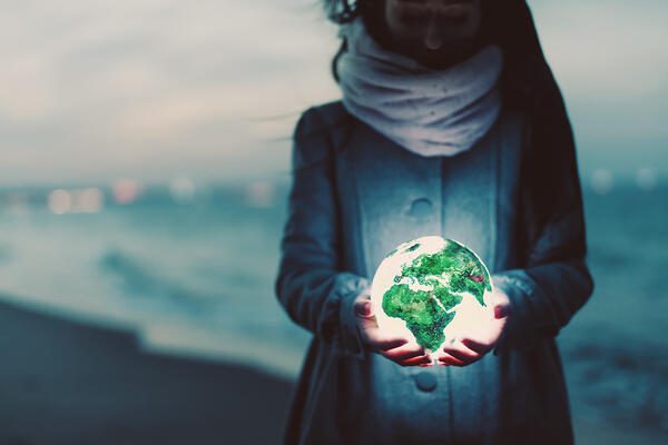 earth globe glowing in womans hands on the beach a TJ2ABV3 envato, Order of Bards, Ovates & Druids.